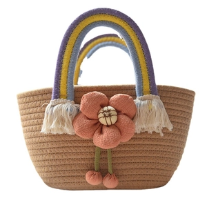 Handwoven brown cotton rope handbag featuring a rainbow handle and orange floral accent