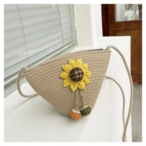 Detailed macro view of straw woven bag with sunflower decoration and colorful tassels