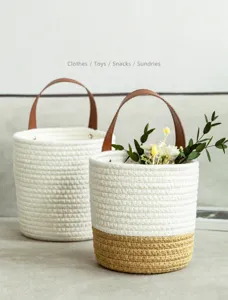 Detailed view of woven cotton rope baskets with leather handles for home storage