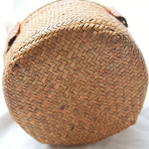 Detailed close-up showing the intricate weave of a natural seagrass storage basket