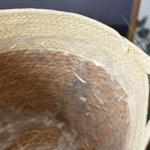 Natural hand-woven grass planter basket with waterproof plastic liner for home storage