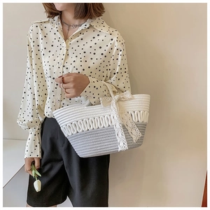 Detailed close-up of handmade rope-woven handbag with wave texture and lace bow