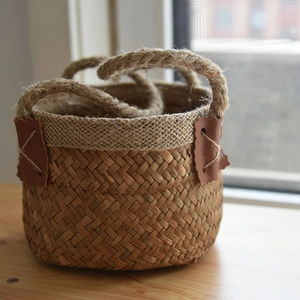 Detailed close-up of handmade seagrass basket with thick jute handles and leather patch