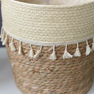 Handwoven straw flower pot with white fringe tassels for bohemian home decor and storage