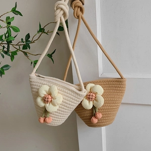 Handmade woven cotton bucket bag with floral decor and cherry charms for summer beach trips