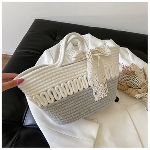 Close-up of handmade woven tote bag featuring wavy texture and elegant lace bow detail