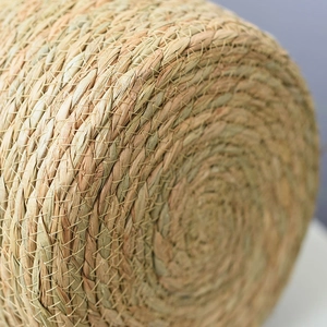 Macro shot of handcrafted seagrass basket showing detailed spiral weave and fiber texture