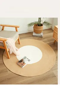 Detail of round woven cotton floor mat with dual-tone concentric circle design