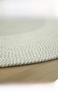 Detail of spiral woven cotton rug texture showing durable grey and white fiber craftsmanship