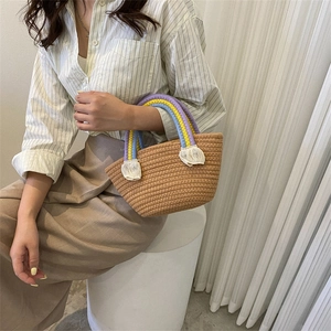 Handmade rainbow straw tote bag with colorful handles and fringe for beach vacation style