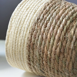 Detailed macro view of natural seagrass weaving texture and fine white stitching work