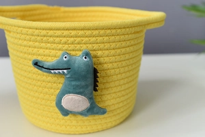 Detail showing bright yellow cotton rope weaving texture and cute green crocodile decor