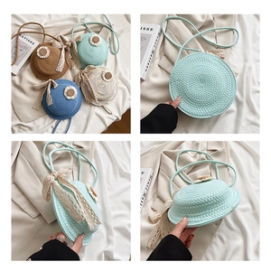 Detail of mini straw hat crossbody bag featuring daisy flowers and lace bow accents