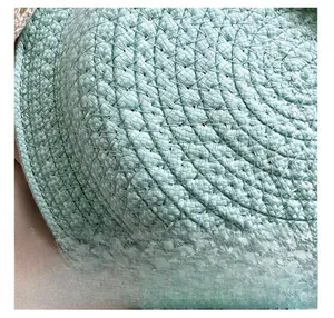 Close-up of fine woven texture on a mint green straw bag with high-quality craftsmanship