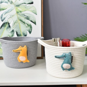 Detail of woven cotton baskets with handles and cute plush crocodile applique patches
