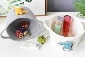 Detail showing two-tone cotton rope baskets with cute 3D crocodile animal decorations