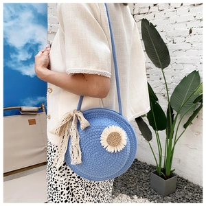 Blue circular straw crossbody bag with white daisy flower and lace bow decoration