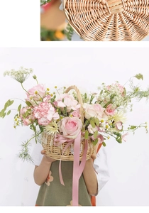 Detail of woven rattan basket with pink roses, carnations and a decorative satin ribbon