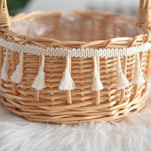 Handwoven wicker flower basket with decorative tassel fringe and clear inner lining