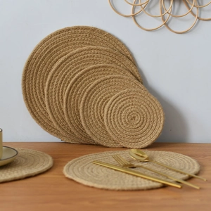Detailed top view of natural jute braided placemats and coasters in five various sizes