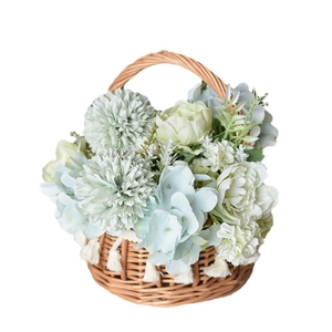 Handwoven wicker flower basket with artificial bouquets and white cotton tassels decor