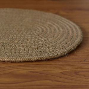 Macro shot of durable braided jute placemat showing natural fibers and spiral texture