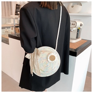 Detail of round straw bag featuring rainbow wave texture and daisy flower ornament