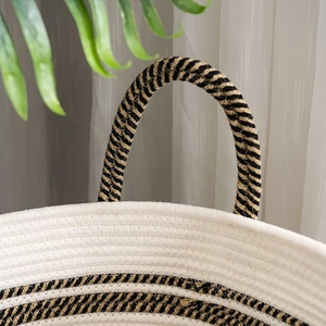 Detailed close-up of woven cotton rope basket with dual-tone handles and striped pattern