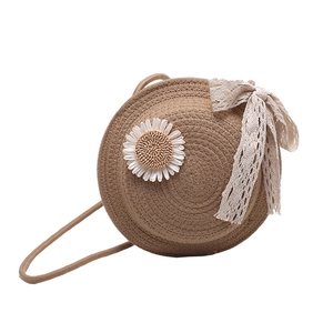 Handmade round straw crossbody bag with white daisy decoration and elegant lace bow