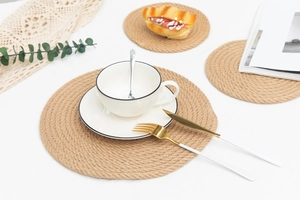 Detail of round braided jute placemat with thick heat-resistant natural fiber texture