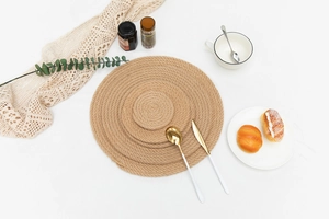 Three-piece set of woven jute placemats in natural wood tones with spiral texture