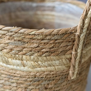 Detail of hand-woven straw basket texture with waterproof plastic lining for indoor plants