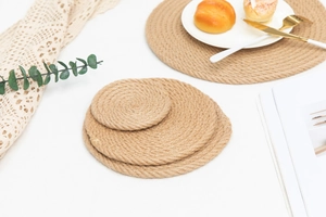 Detail of round woven jute placemats with heat resistant spiral texture in home setting