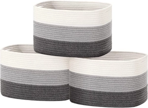 Detailed macro view of woven cotton rope storage baskets in gray and white gradient colors