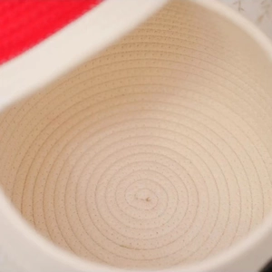 Close-up of woven cotton rope texture and spiral pattern on the bottom of storage basket