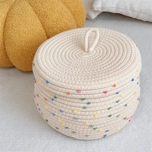 Detail of Nordic cotton rope storage basket with lid showing colorful woven texture