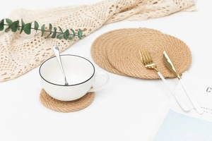 Close-up of thick round jute coaster with natural spiral braided texture and rustic finish
