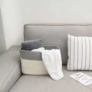 Gray and white cotton rope woven storage basket for organizing home blankets and pillows
