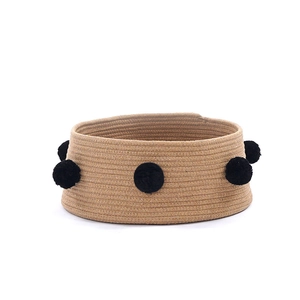 Handwoven round cotton rope pet bed for cats and dogs with black pompom decorative accents