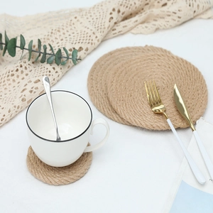 Natural jute woven placemat set with a rustic round braided design and heat insulation