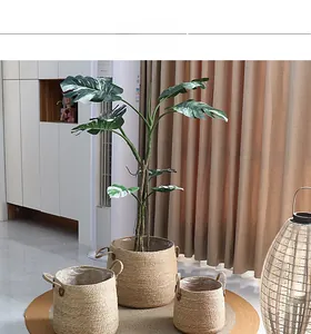 Close-up of woven seagrass plant baskets with leather handles and waterproof liners