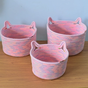 Set of 3 pink woven storage baskets with cute cat ear handles for desktop organization