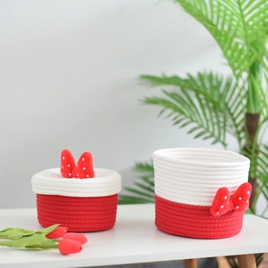 Detail of red and white cotton rope woven storage baskets with 3D bowknot decorations