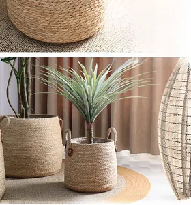 Detail of hand-woven natural plant fiber planter with round handles and dense texture
