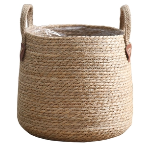 Minimalist woven straw planter basket with leather handles and plastic liner