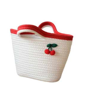 Handmade woven cotton rope tote bag with cherry charms and red handles for beach vacation