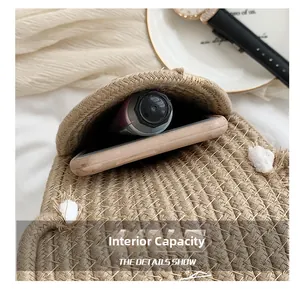 Macro view of interior capacity of the straw woven phone bag with everyday items