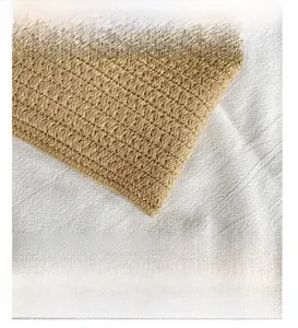 Close-up of natural woven straw bag showing detailed twill weaving and quality texture