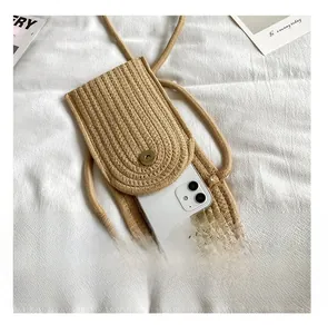 Detailed interior view showing space for a smartphone in a woven crossbody bag