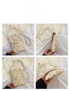 Detail of hand-woven mini straw phone bag with colorful dots and large pearl closure